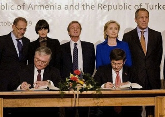 Armenia's Foreign Minister Eduard Nalbandian and then Turkish Foreign Minister Ahmet Davutoglu sign the protocols in Switzerland on Oct. 10, 2010