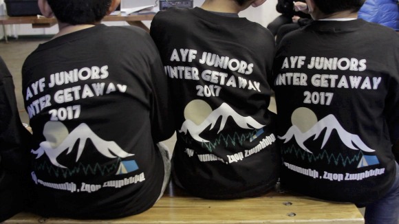 AYF Juniors with farewell gifted long sleeves that read Հզօր Պատանի, Հզօր Հայրենիք/Hzor Badani, Hzor Hayrenik/Strong Badani, Strong Fatherland 