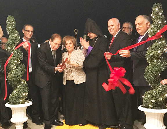 Mr. and Mrs. Garo and Alice Gureghian (center) are flanked by community leaders and the Prelate following the ribbon cutting ceremony