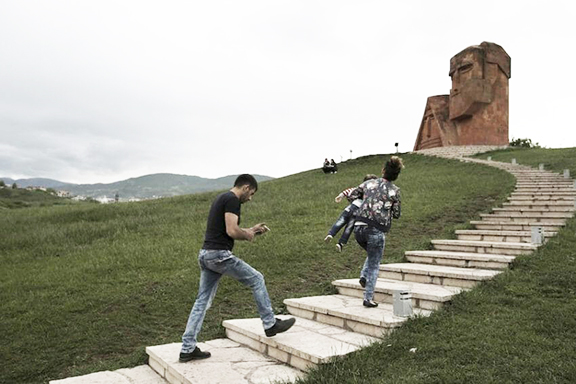 Visitors climb the stairs to the "We are Our Mountains" monument in Artsakh