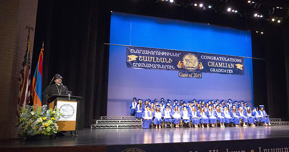 Western Prelate Archbishop Moushegh Mardirossian addresses attendees of Chamlian's 8th grade graduation at Glendale High School on June 13