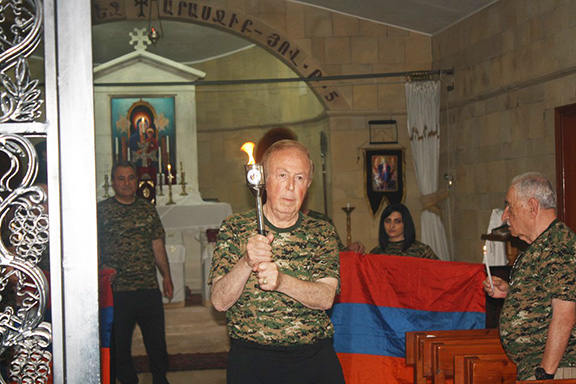 Pan-Armenian Games committee chairman Albert Boyajian with the official torch, which will travel to Arttakh